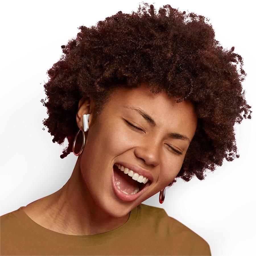 A black female model wearing QCY MeloBuds ANC