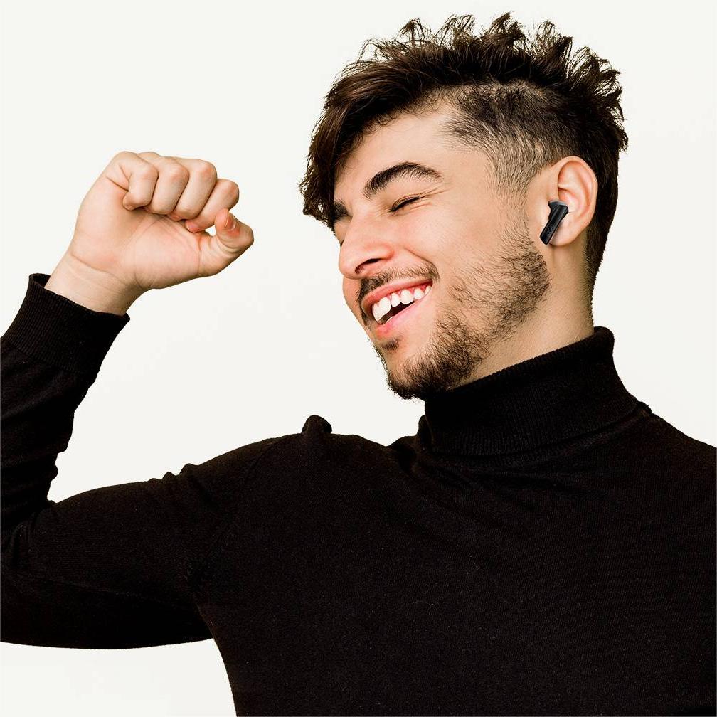 A male model wearing QCY MeloBuds ANC headphones